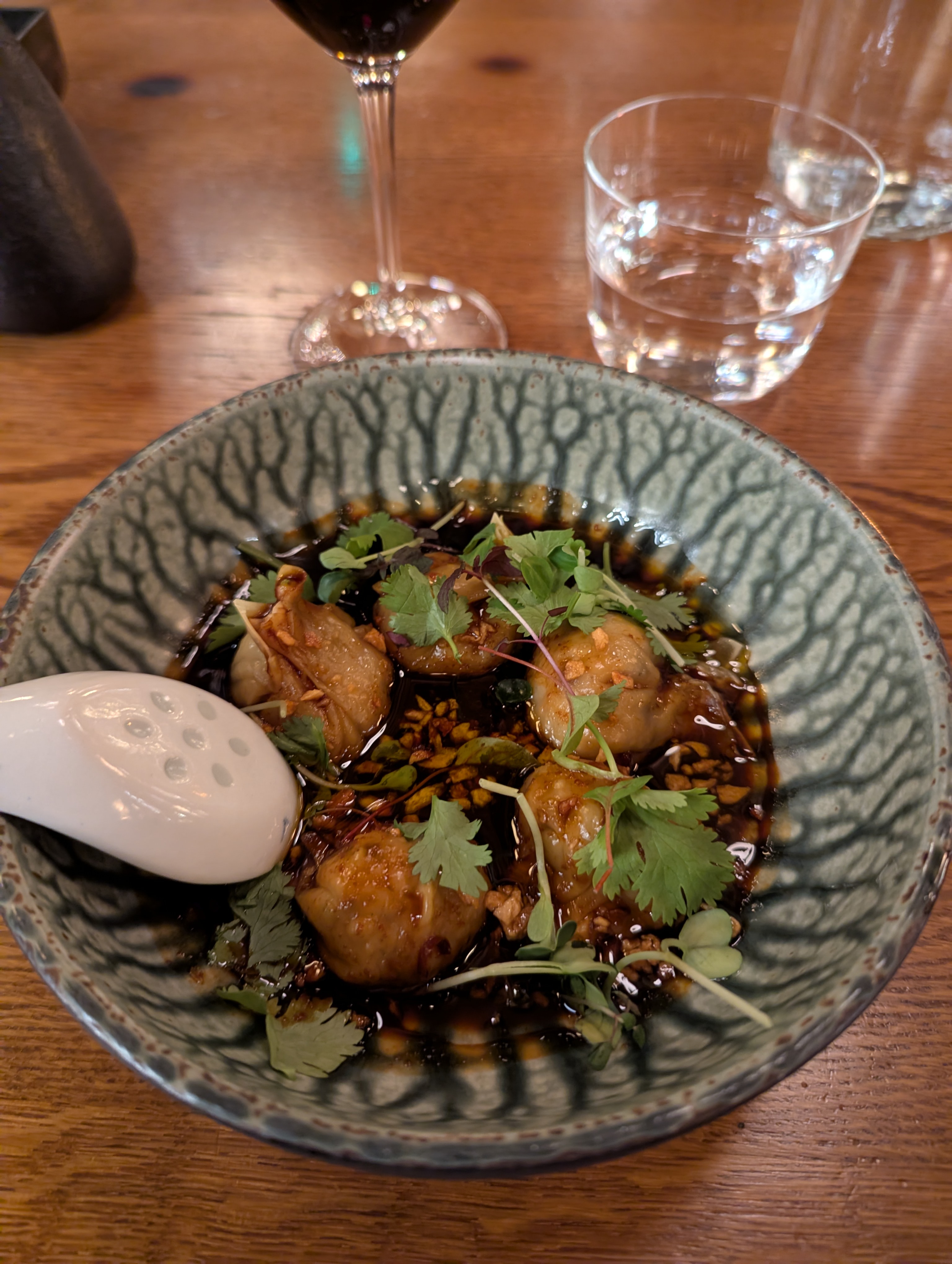 Yam Wontons, steamed shrimp wontons, spicy soy vinaigrette, cilantro, chili, fried garlic. Click to open full size image.